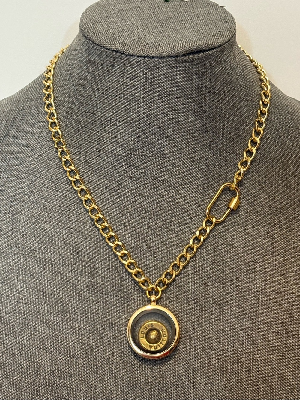 Authentic Louis Vuitton Grommet and Rivet charm encased in gold and glass locket